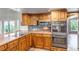 Modern kitchen featuring stainless steel appliances, granite countertops, and a cooktop with double oven at 3254 Red Tree Pl, Castle Rock, CO 80104