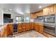 Well-equipped kitchen with a wine cooler, stainless steel appliances, and a breakfast bar at 3254 Red Tree Pl, Castle Rock, CO 80104