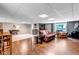 Open-concept living area with hardwood floors, a leather sofa, and lots of natural light at 3254 Red Tree Pl, Castle Rock, CO 80104
