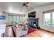 Comfortable living room with hardwood floors, a fireplace, large windows, and an open floor plan at 3254 Red Tree Pl, Castle Rock, CO 80104