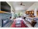 Inviting living room area with a fireplace, hardwood floors, an open floor plan, and access to an outdoor deck at 3254 Red Tree Pl, Castle Rock, CO 80104