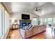 Inviting living room featuring a brick fireplace, hardwood floors, and sliding glass doors to outdoor area at 3254 Red Tree Pl, Castle Rock, CO 80104