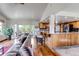 Open concept living room and kitchen area with beautiful hardwood floors and a view to the outside deck at 3254 Red Tree Pl, Castle Rock, CO 80104