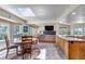 Open-concept living space with dining area, kitchen, and a cozy fireplace at 3254 Red Tree Pl, Castle Rock, CO 80104