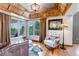 Cozy sitting area with tray ceiling, hardwood floors, large windows, and plenty of natural light at 3254 Red Tree Pl, Castle Rock, CO 80104
