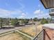 Balcony view overlooking a neighborhood with trees and walking trails on a bright day at 9019 E Panorama Cir # D217, Englewood, CO 80112