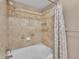 Bathroom features a shower over a tub with tiled walls, decorative trim, and a shower curtain at 9019 E Panorama Cir # D217, Englewood, CO 80112