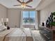 Cozy bedroom with natural light from a large window and a stylish dresser for storage at 9019 E Panorama Cir # D217, Englewood, CO 80112
