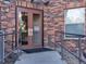 Apartment building entrance with brick facade, glass doors, and access ramp at 9019 E Panorama Cir # D217, Englewood, CO 80112