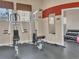 Full gym with workout equipment, weights, and a mirrored wall, perfect for a full body workout at 9019 E Panorama Cir # D217, Englewood, CO 80112