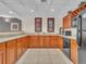 Kitchenette area with a large counter, cabinets, stainless steel microwave, and tile flooring at 9019 E Panorama Cir # D217, Englewood, CO 80112