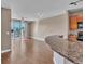 Open floor plan with hardwood floors, leading from the kitchen to the living area and balcony at 9019 E Panorama Cir # D217, Englewood, CO 80112