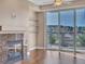 Bright living room featuring hardwood floors, a granite fireplace, and access to a balcony with views at 9019 E Panorama Cir # D217, Englewood, CO 80112