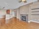 Open-concept living space with fireplace, hardwood floors, and bar stool seating to the kitchen at 9019 E Panorama Cir # D217, Englewood, CO 80112