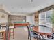 Spacious recreation room with a pool table, seating, and natural light from the large window at 9019 E Panorama Cir # D217, Englewood, CO 80112