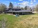 Aerial view of a home with a spacious yard, patio, and mature trees at 5752 S Jasmine St, Greenwood Village, CO 80111