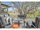 Outdoor patio area with seating, dining table, and a large tree for shade at 5752 S Jasmine St, Greenwood Village, CO 80111