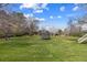 Large backyard with a swing, trampoline, lush grass, and mature trees on a sunny day at 5752 S Jasmine St, Greenwood Village, CO 80111