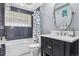 Stylish bathroom with modern fixtures, bathtub with shower and glass block window at 5752 S Jasmine St, Greenwood Village, CO 80111