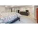 Open-concept bedroom with a comfortable bed, seating area, and neutral decor at 5752 S Jasmine St, Greenwood Village, CO 80111