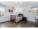 Bedroom with wood floors, airplane-themed decor, and bright blue walls with light filtering through the windows at 5752 S Jasmine St, Greenwood Village, CO 80111