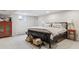 Comfortable bedroom with a large bed, side tables, and an orange dresser at 5752 S Jasmine St, Greenwood Village, CO 80111