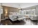 Primary bedroom suite with beautiful light fixture, decorative wallpaper, and large windows at 5752 S Jasmine St, Greenwood Village, CO 80111