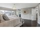 Bright bedroom featuring dark wood floors, overhead light, and access to the primary bathroom at 5752 S Jasmine St, Greenwood Village, CO 80111