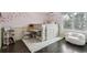 Charming bedroom featuring built-in bed with desk and storage, with butterfly decor on pink wall at 5752 S Jasmine St, Greenwood Village, CO 80111