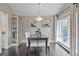 Elegant dining room featuring hardwood floors, a chandelier, and a bright window with curtains at 5752 S Jasmine St, Greenwood Village, CO 80111