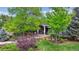 Charming home exterior with manicured front yard, mature trees, and inviting entryway at 5752 S Jasmine St, Greenwood Village, CO 80111