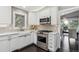 Well-lit kitchen features white cabinets, stainless steel appliances, and undermount sink by the window at 5752 S Jasmine St, Greenwood Village, CO 80111