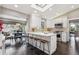 Bright kitchen featuring white cabinets, a center island with seating, and stainless steel appliances at 5752 S Jasmine St, Greenwood Village, CO 80111