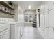 Bright laundry room featuring white cabinets, wood shelves, and a window at 5752 S Jasmine St, Greenwood Village, CO 80111