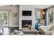 Stylish living room featuring a white stone fireplace, large windows, and comfortable seating at 5752 S Jasmine St, Greenwood Village, CO 80111