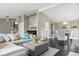 Spacious living area with dark wood floors, stone fireplace, and open access to dining area at 5752 S Jasmine St, Greenwood Village, CO 80111