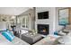 Cozy living area with a modern fireplace, hardwood floors, and adjacent dining space at 5752 S Jasmine St, Greenwood Village, CO 80111