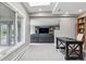 Spacious office area with large desk, and a peek into the adjacent living room at 5752 S Jasmine St, Greenwood Village, CO 80111