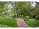 Stone pathway through landscaped grounds and flowering garden beds at 5752 S Jasmine St, Greenwood Village, CO 80111
