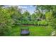 Backyard view showcasing lush lawn, a trampoline, and mature trees at 5752 S Jasmine St, Greenwood Village, CO 80111