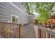 Backyard showing access with a wood fence, rocks, and grass at 19688 E Lasalle Dr, Aurora, CO 80013