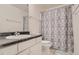 Bathroom featuring white vanity, toilet, decorative shower curtain, and grey-blue accents at 19688 E Lasalle Dr, Aurora, CO 80013