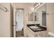 Bathroom featuring a vanity with a marble countertop, mirror, and open doorway to bedroom at 19688 E Lasalle Dr, Aurora, CO 80013