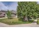 Well-maintained home with a green lawn and mature trees, offering a welcoming curb appeal at 19688 E Lasalle Dr, Aurora, CO 80013