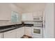 Functional kitchen with white cabinets and appliances, offering a clean and efficient cooking space at 19688 E Lasalle Dr, Aurora, CO 80013