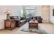 Inviting living room with leather sofas, a large window, and stylish decor creating a cozy atmosphere at 19688 E Lasalle Dr, Aurora, CO 80013