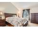 Bedroom featuring a large bed with patterned bedding and a dark wood dresser at 19688 E Lasalle Dr, Aurora, CO 80013