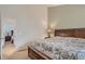 Bedroom featuring large bed and doorway leading to another bedroom; side tables are visible at 19688 E Lasalle Dr, Aurora, CO 80013