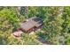 Aerial view of the property showcasing the home's layout, mature trees, and outdoor entertaining areas at 1 Lindenwood Dr, Littleton, CO 80120