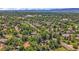 Residential area showcases lush landscaping, mature trees, and houses with private pools at 1 Lindenwood Dr, Littleton, CO 80120